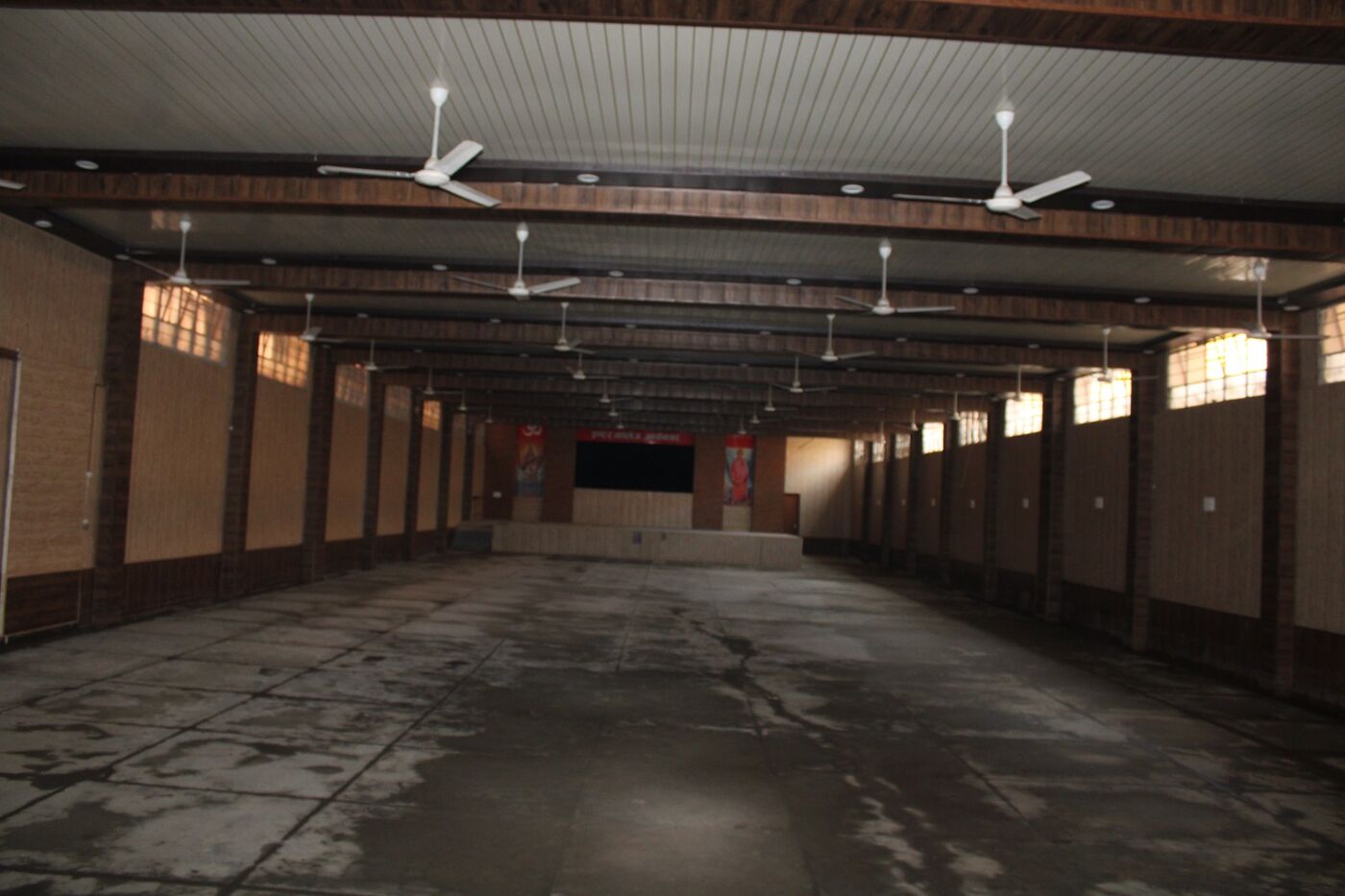 Covered hall with a high roof and ceiling fans used for large gatherings