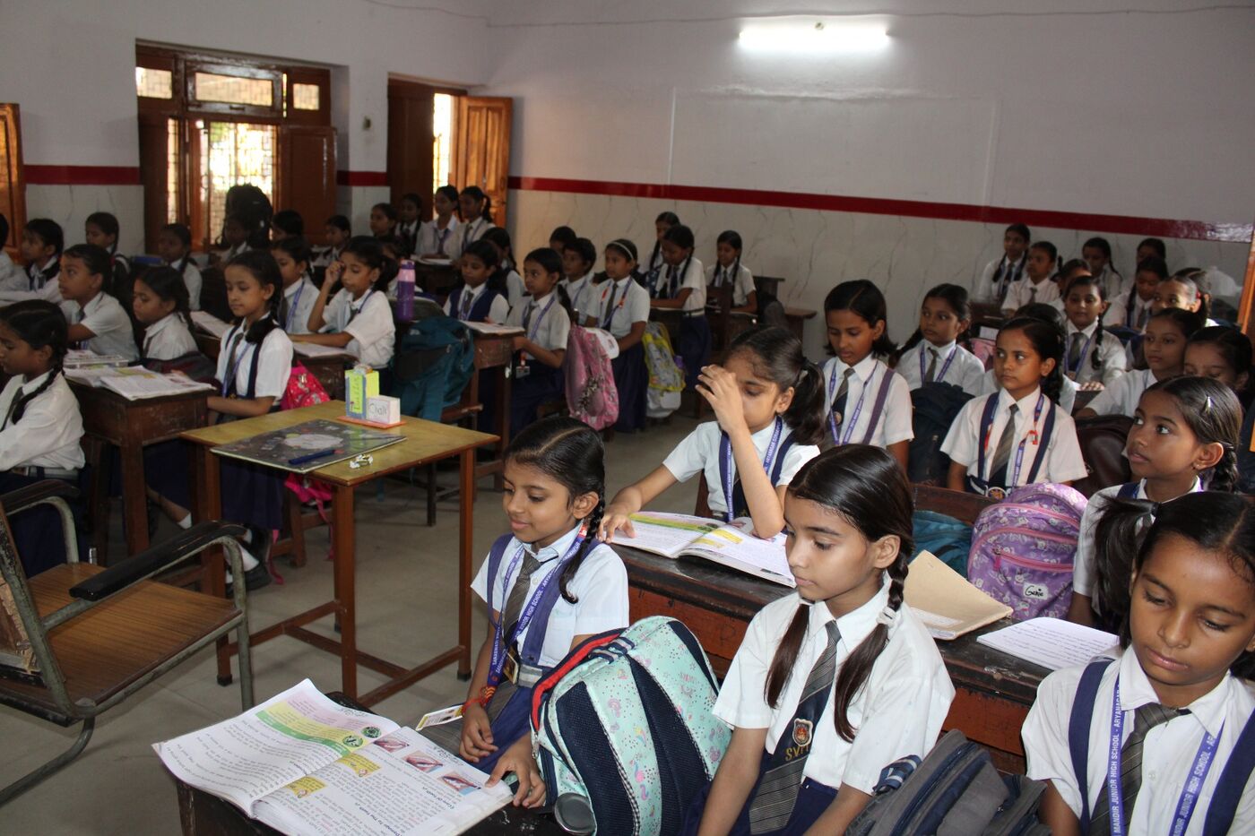 Girl students seated with their books in a classroom of the girls' section