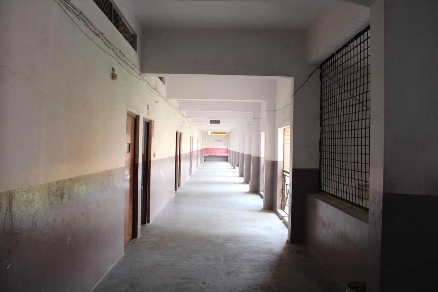 Corridor lined with classroom doors on the teaching floor
