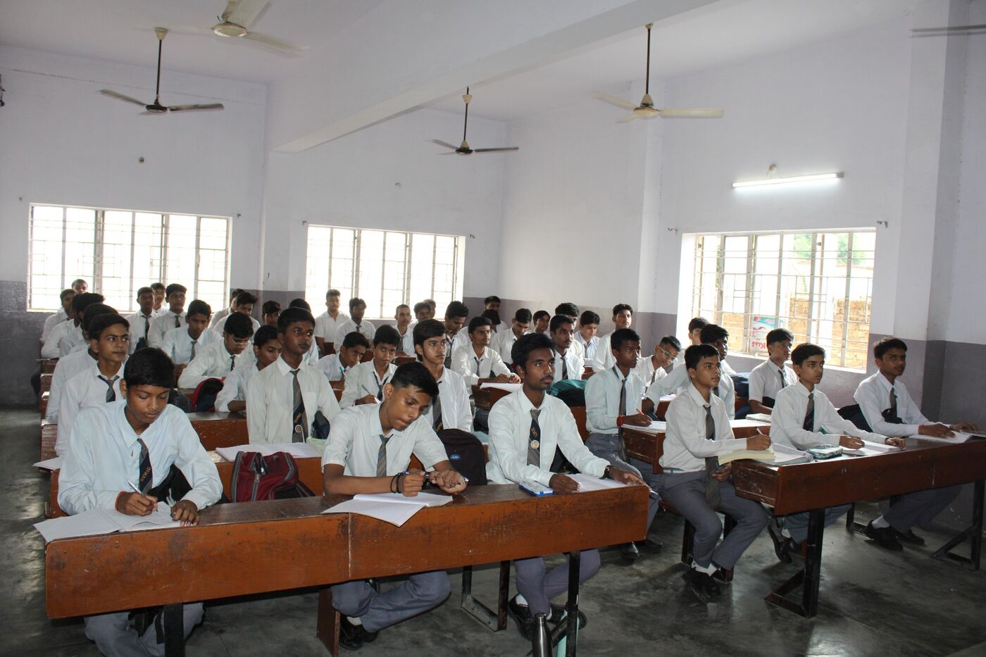 Students writing at their desks during a lesson