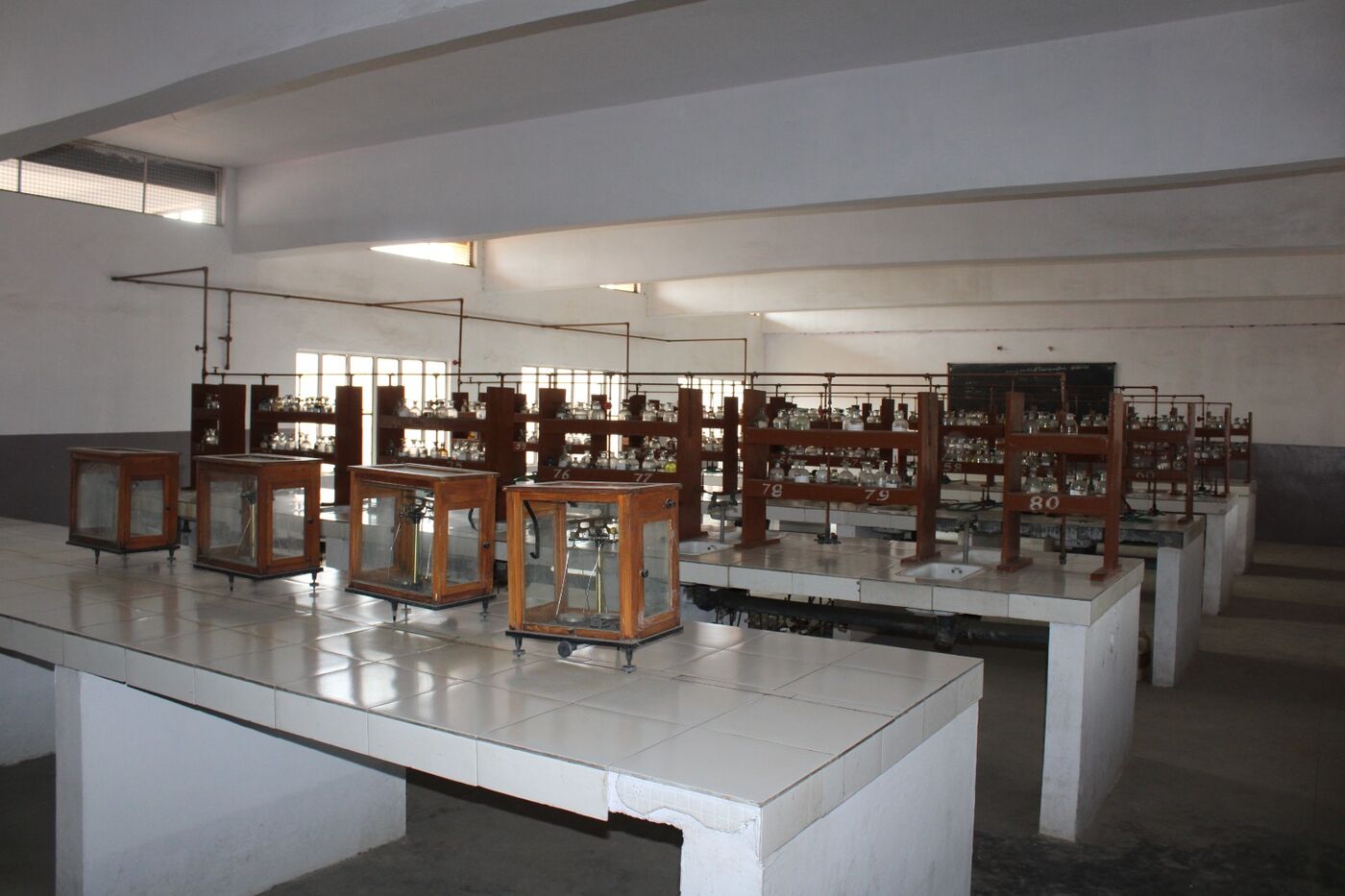 Physics laboratory with wooden apparatus stands arranged on the working tables