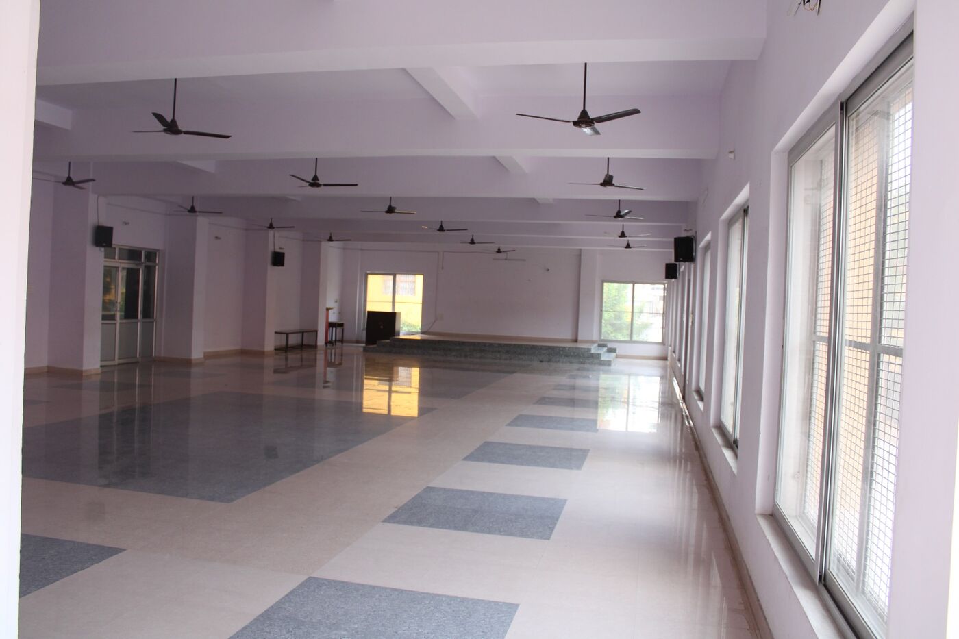 Bright tiled common hall with windows along one wall